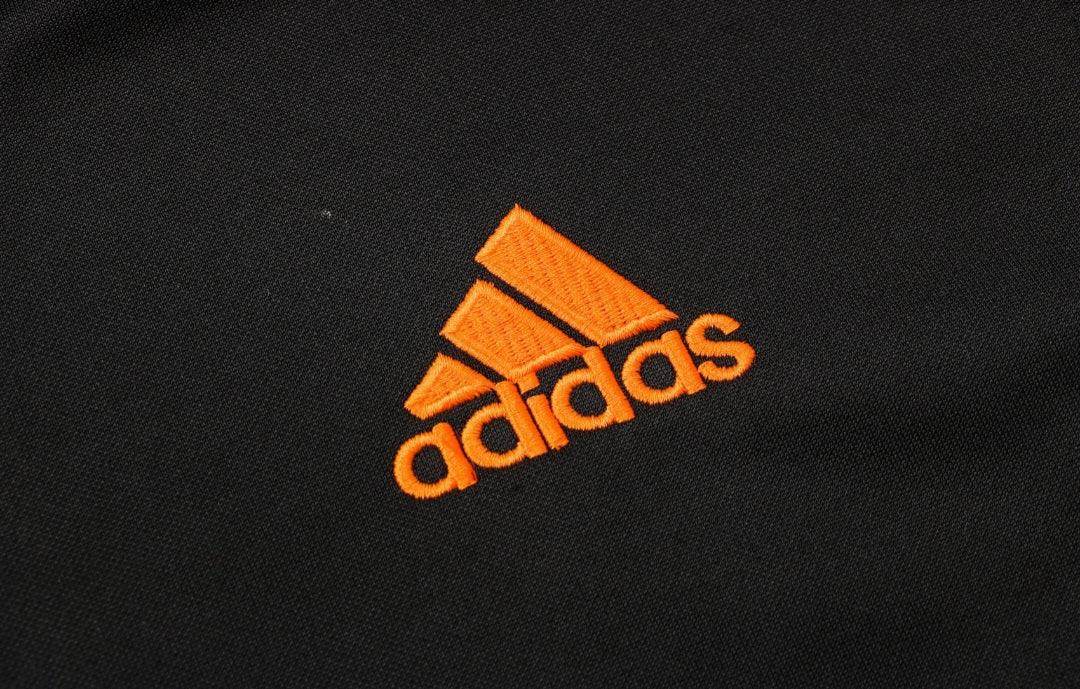 Real Madrid Black and Orange Tracksuit - JerseyLegacy